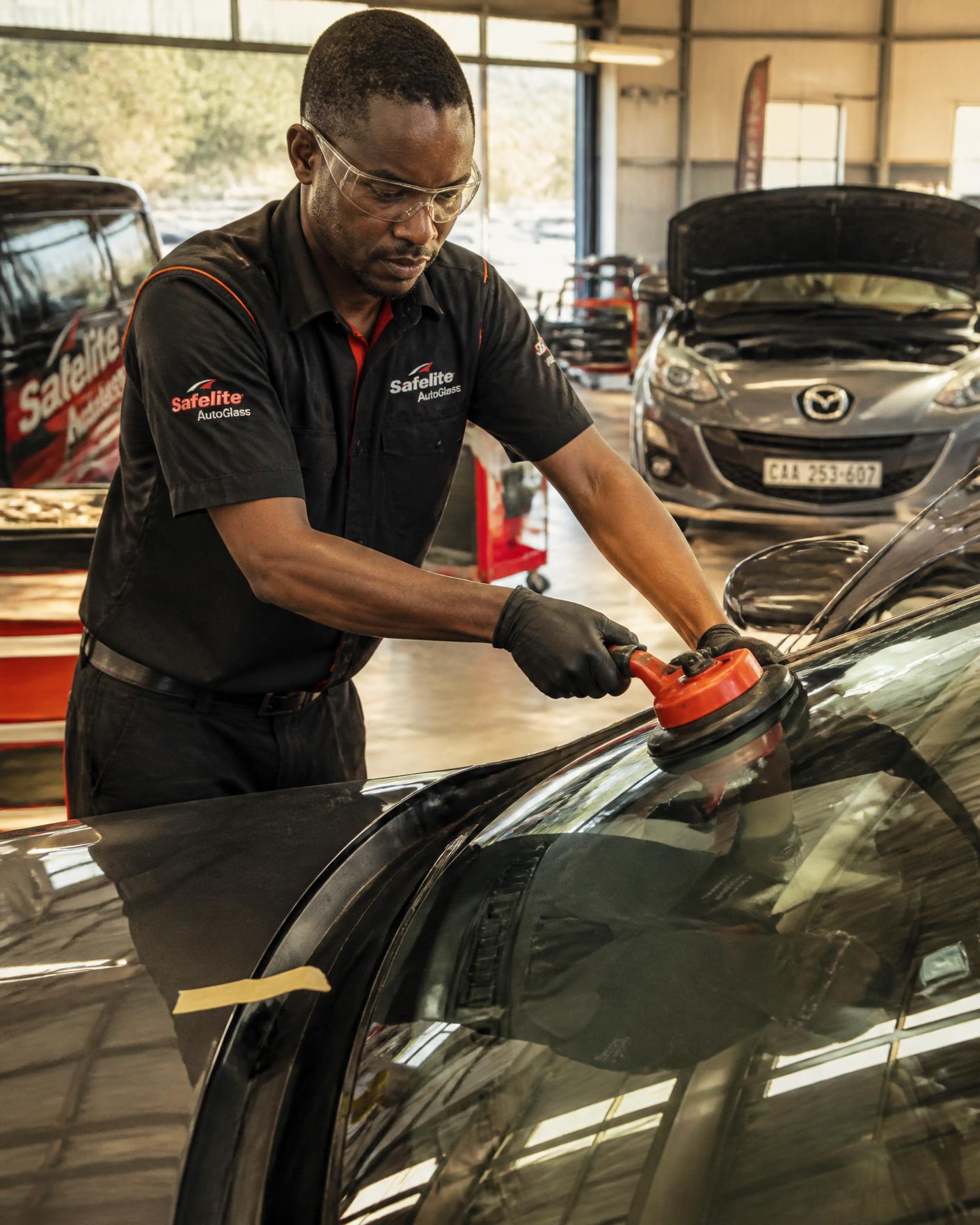 Windscreen Lab specialist performing precision ADAS camera calibration in a controlled workshop